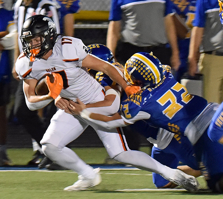 A pair of Bobcats make Cody Milliman their prey as the Spartans battle Benton Community Friday, Sept. 19 in Van Horne. The Spartans held off the ‘Cats for a 28-21 win to stay undefeated at 4-0.