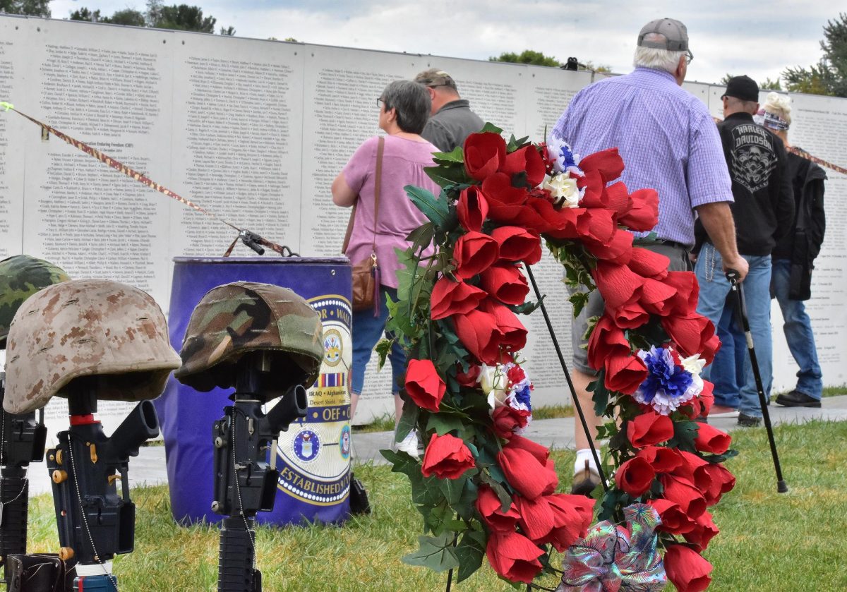 Veterans and others look for the names of fallen comrades, friends, or family members on the Global War on Terror Wall of Remembrance Saturday, Sept. 20. The 120-foot long memorial and historical display was set up on the Legion’s ballfield and in Solon from Thursday, Sept. 18 through Sunday, Sept. 21 in its first visit to Iowa.