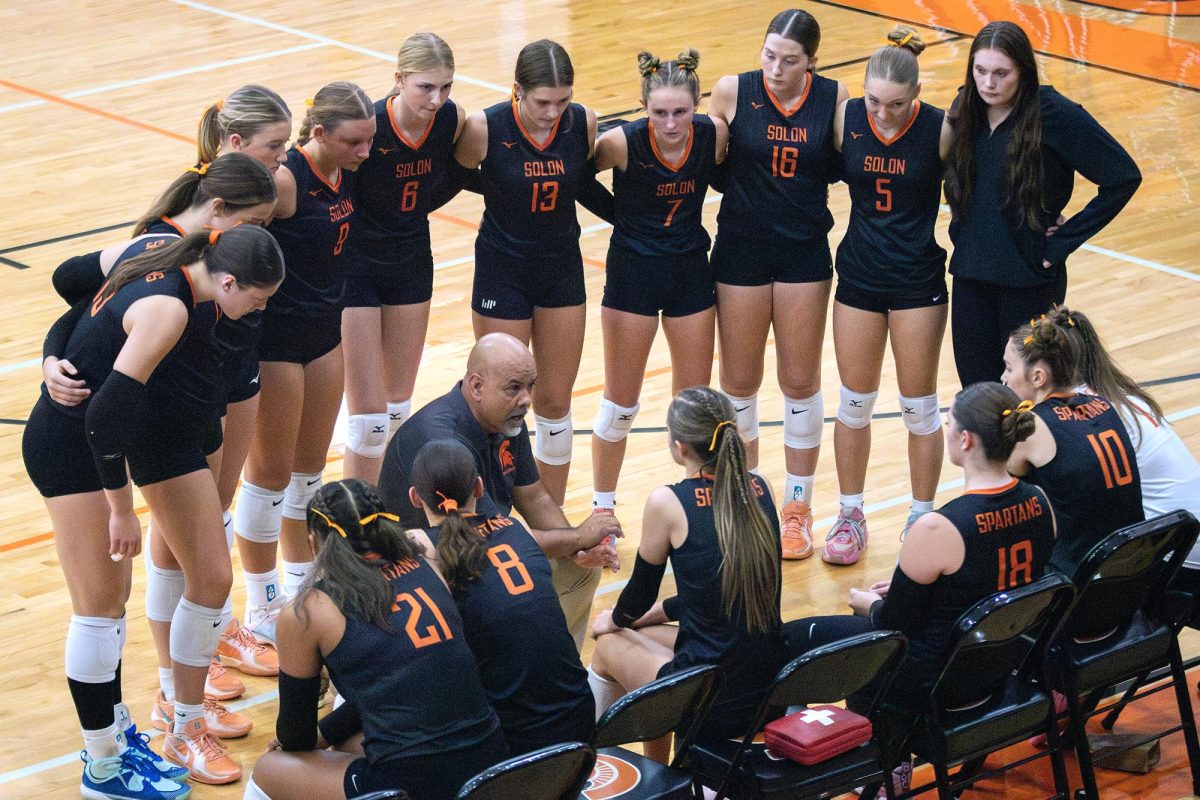 Solon head coach Ruben Galvan addresses his players during a crucial timeout in the third set of their match against West Delaware. The Lady Spartans controlled the match to win 3–0.