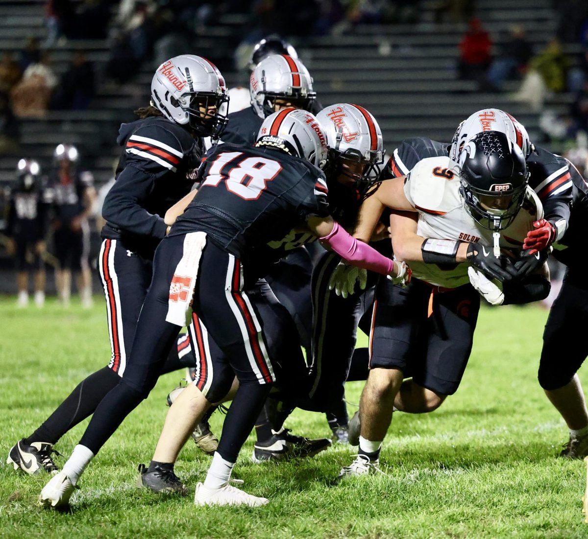 Luis Buck (9), a junior, muscles his way through multiple defenders for yardage Friday, October 24 in Fort Madison. The Spartans closed out the regular season with a 51-2 win for a 9-0 record going into the Class 3A playoffs.