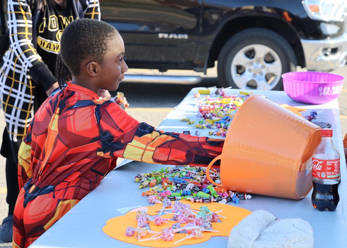 A young trick-or-treater dressed as a superhero picked out candy from a table display during Solon’s Monster Mash Trunk or Treat celebration Sunday, October 26 at the SRNA.
