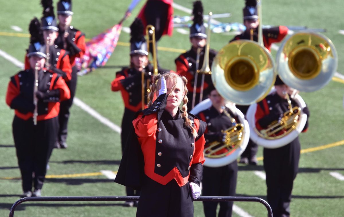 Drum Major Evann Freerks salutes at the conclusion of the Solon Marching Band’s 2025 halftime show, Cirque’ Du Solon, at the State Marching Band Competition Saturday, October 11, at Kingston Stadium in Cedar Rapids. The band and color guard were awarded a Division I (highest) rating, their first since 2017.