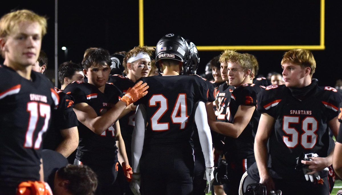 Gavin Wisman (24), a senior, enters the “tunnel” made up of teammates and senior parents as Senior Night draws to a close Friday, October 10.
