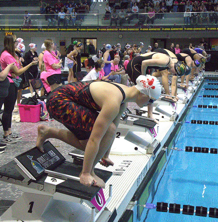 Madelyn Elkins lines up on the block ready to compete in the 50-yard freestyle at the 2025 IGHSAU State Swimming Preliminaries in Iowa City, Iowa, Thursday, November 13, 2025.