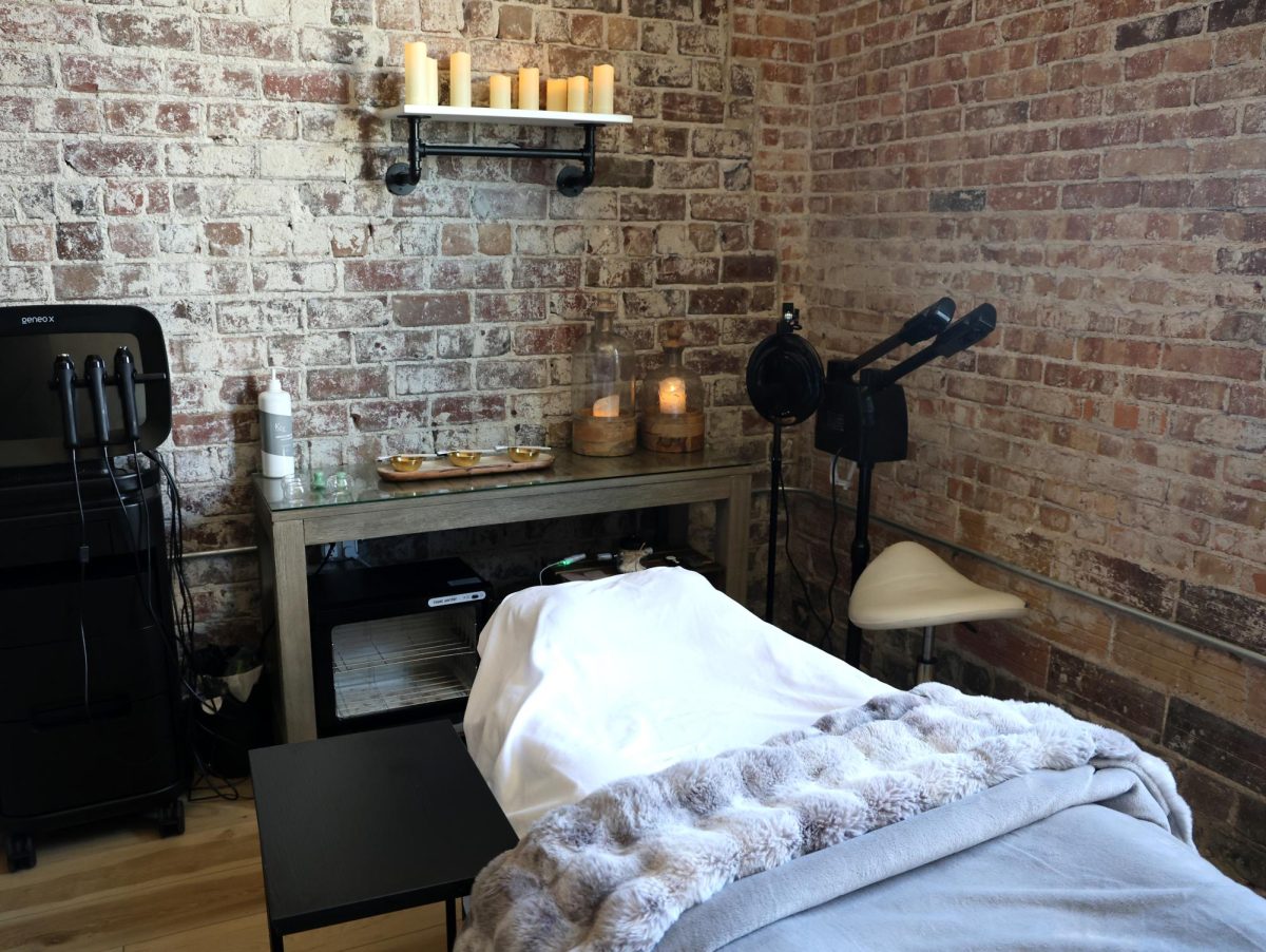 The inside of MedSpa Solon, located on the ground floor of the Literary Hotel at 130 S. Dubuque St., Suite 106, features soft lighting, exposed brick, and a spa bed prepared for clients seeking facials and aesthetic services.