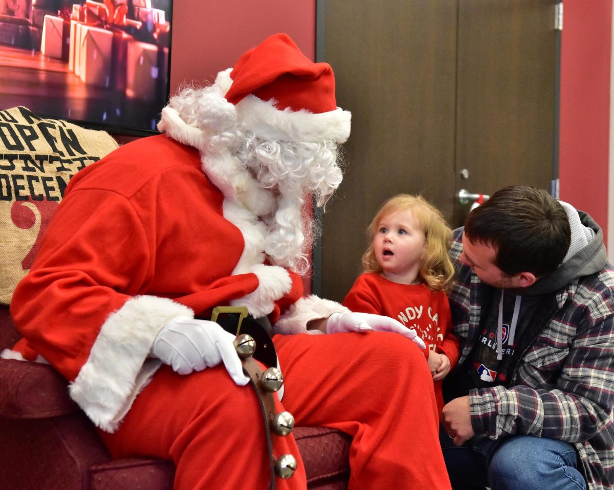 Lennon Brimeyer appears to be in awe of Santa Claus as she (with encouragement and support from dad Travis Brimeyer) asks the Jolly Old Elf for Christmas goodies during a Dec. 13, 2024 visit to the Solon Fire Department.