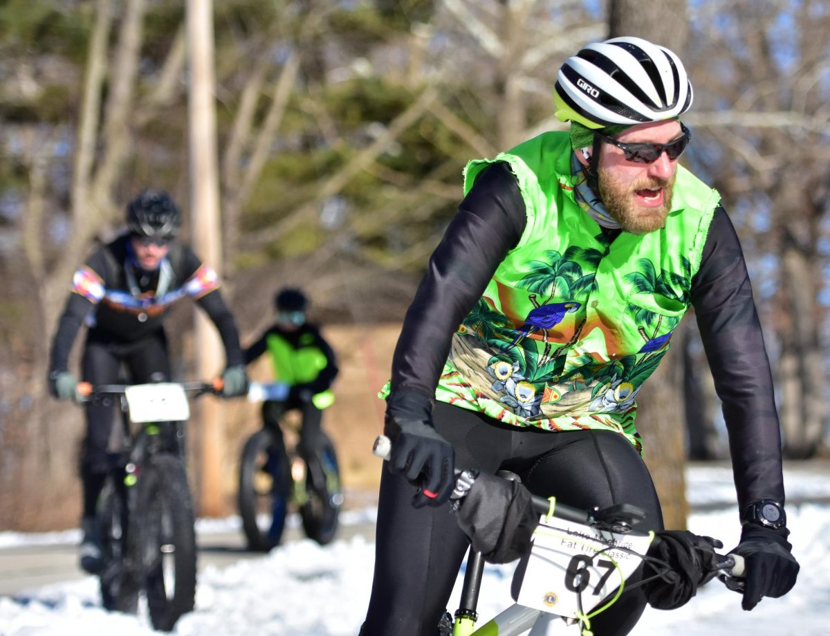 Joshua Kappelman (67) leads a pack of riders down a sharp and steep turn during the sixth annual Fat Tire Classic bike race at Lake Macbride State Park, Saturday, Feb. 11, 2023. This year’s event will be held this Saturday.