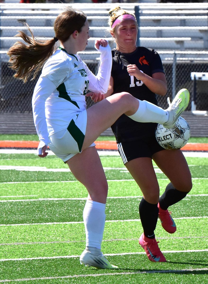 Iowa City West High’s Emma
Meade (20) tries to steal the ball
from Laeni Hinkle during a nonconference match between the Class 3A Trojans and 1A Lady Spartans Saturday, April 18, in Solon.