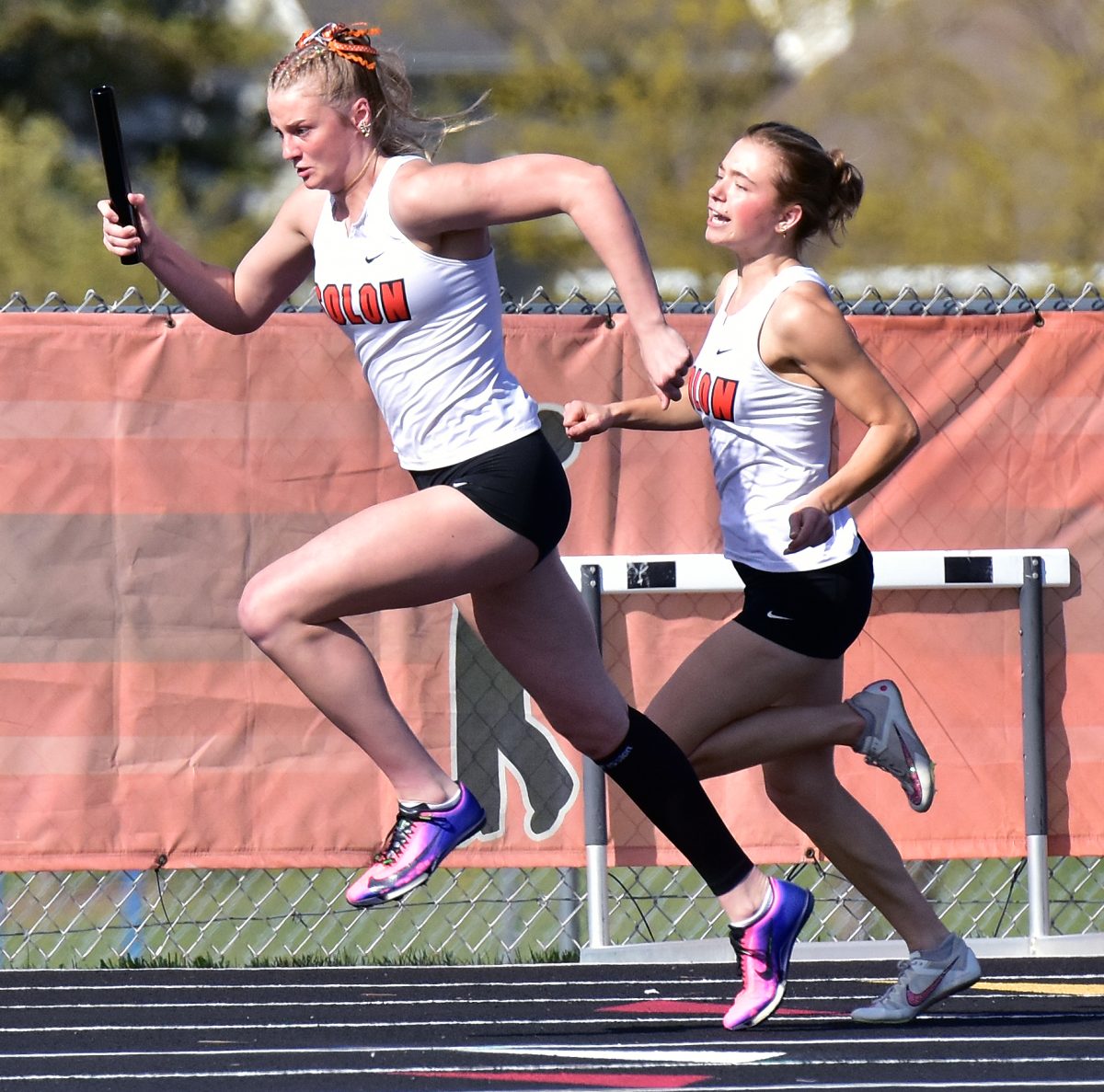 Tenley Levin takes the baton from Marin Ashbacker for her leg of the 800-meter sprint medley relay Tuesday, April 21 at Solon’s home Denny Gruber Relays. Sydney Kunkel, Ashbacker, Levin, and Jerzey Haluska took second in 1:51.60.