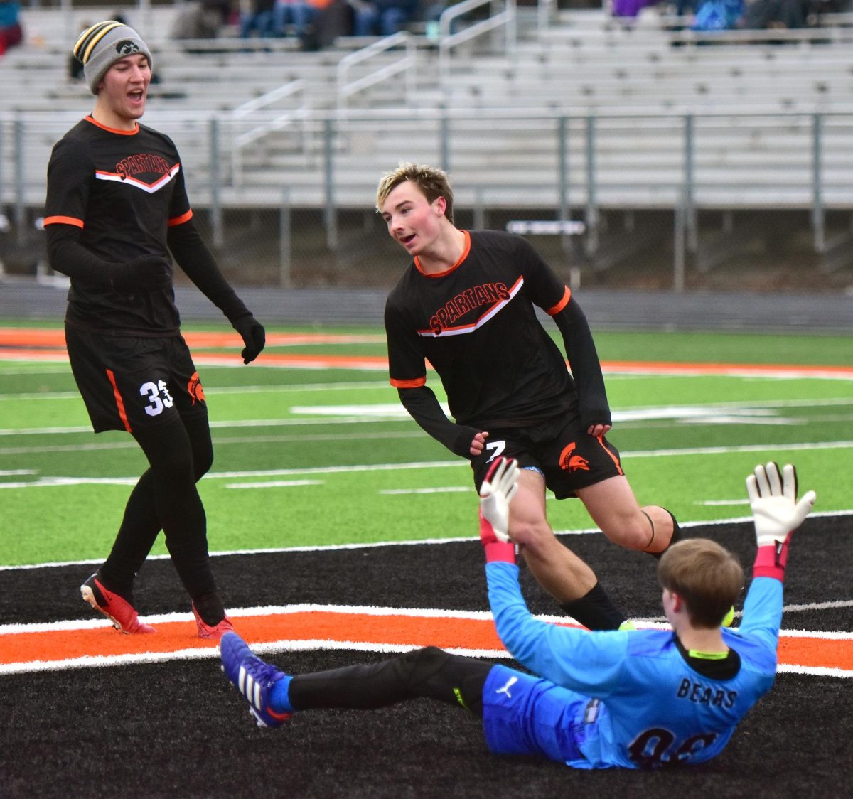 Ryan Locke (33, at left) and Ethan Ulch (7) celebrate Ulch’s goal while West Branch’s keeper cries foul Saturday, April 4, during Solon’s varsity triangular match against the Bears and Clinton River Kings. The Spartans defeated West Branch 3-1 with two goals from Ulch, a senior.