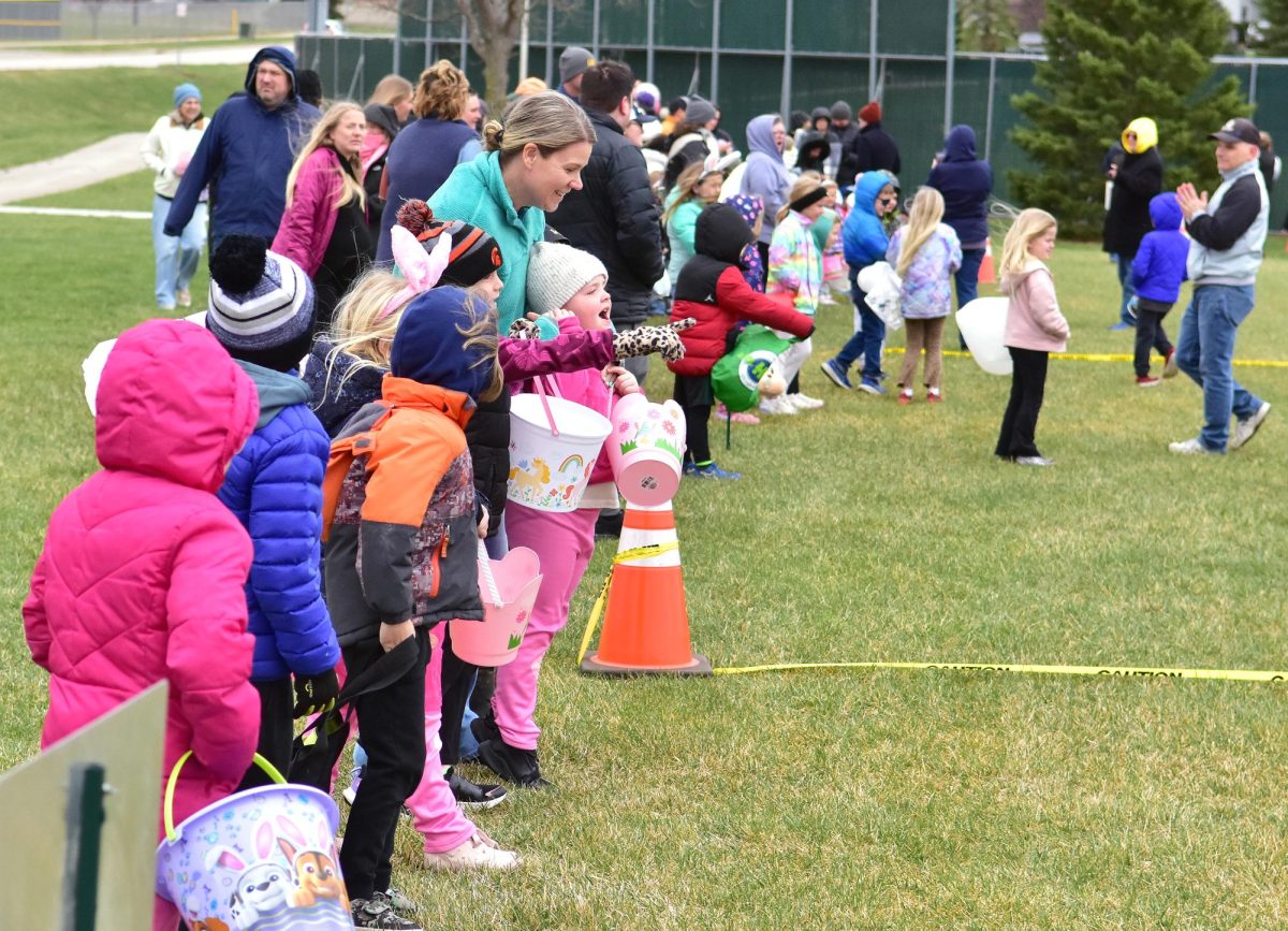 Two girls spotted one of three special gold eggs (containing a tiny teddy bear) scattered among the 3,456 plastic eggs put out Saturday, April 4, for the Solon Optimist Club’s annual Easter Egg hunt at the SRNA.