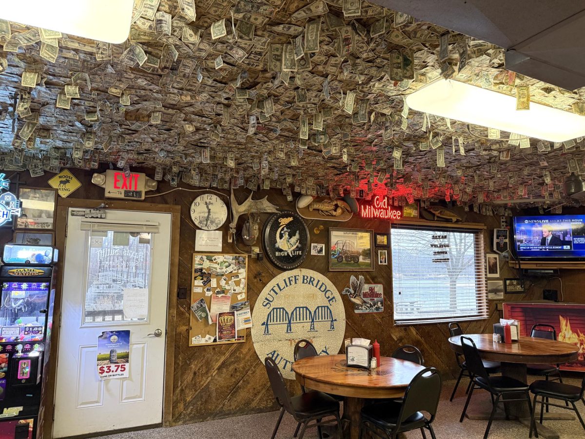 Erin and Tyler Light are the current owners of Baxa’s Sutliff Store & Tavern, continuing a Sutliff tradition dating back to the 1930s. The history of Sutliff, Baxa’s Sutliff Store & Tavern, and memories of friends and families are displayed on the walls of the tavern, located about five miles north of Solon. Across the road from Baxa’s Sutliff Store & Tavern sits the historic Sutliff Bridge. Closed to traffic in 1979 it was partially destroyed in the flood of 2008 and rebuilt with dollars from fundraisers and FEMA. Top left: When first walking into Baxa’s, new customers are immediately caught by the ceilings full of hanging dollar bills – a tradition inadvertently started in the 1970s by a pair of east coast women passing through.