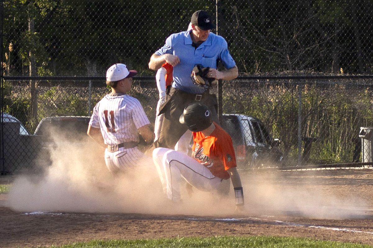 Solon second baseman Caden Bails slides into home during a baseball game between the Solon Spartans and Mount Vernon Mustangs at Ash Park Field in Mount Vernon on Wednesday, May 27, 2026. The Spartans won their first game in a double header that night against the Mustangs, 7-1.