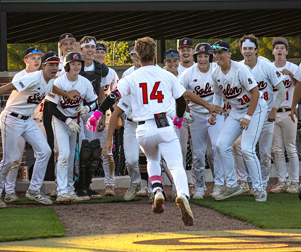 Hayden Detra celebrates with the team after a home run against Grinnell at the SRNA complex on Thursday, June 18.