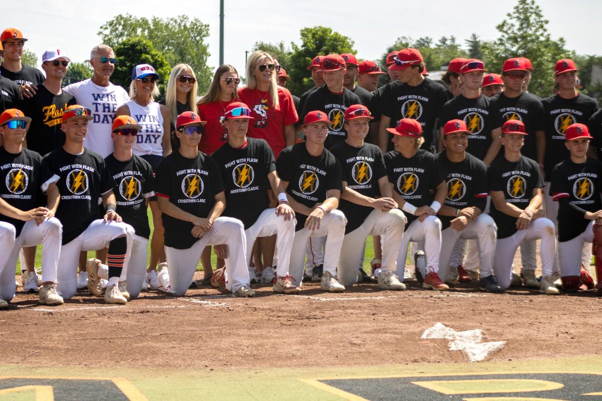 The Schroeder and Sutherland families pose for a portrait with the Solon and Iowa City High baseball teams before the Crosstown Classic game between the Spartans and Little Hawks at the Solon High School Ball Field on Saturday, June 6. Solon beat the Little Hawks 6-3.
