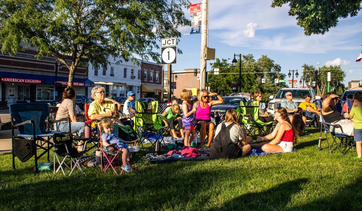Attendees gather in their chairs before the Mill Creek Band’s performance for Music on Main in Solon on Wednesday, June 24. Center left: Guitarist James McAtee sings during the Mill Creek Band’s performance for Music on Main in Solon on Wednesday, June 24.