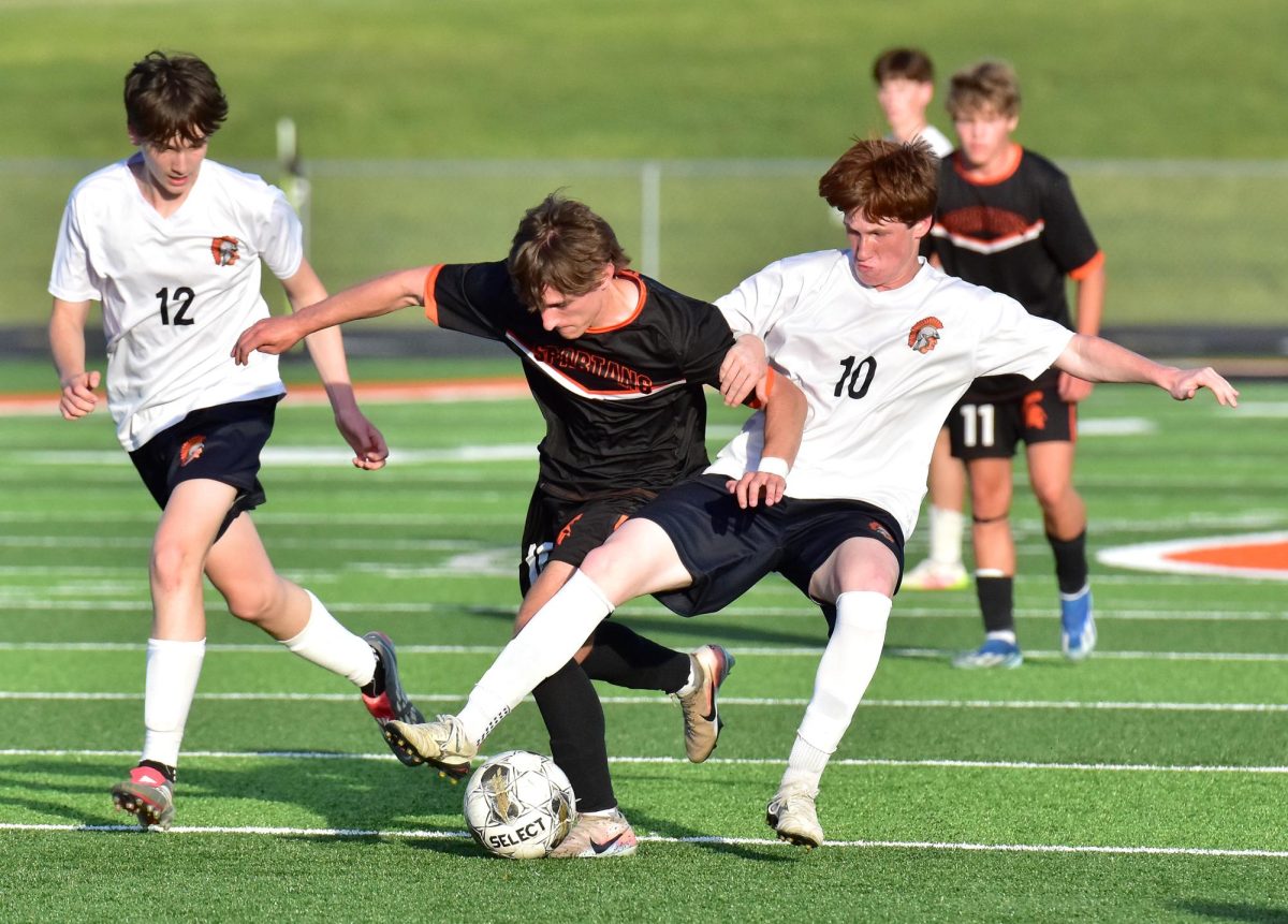 Tucker Spence disposes of Fairfield’s Cormac Van Pelt Wednesday, May 27, in a Class 2A Substate Semifinal match in Solon. The Spartans topped the Trojans 3-1 to advance to the finals Friday, May 29, against archrival Mount Vernon.