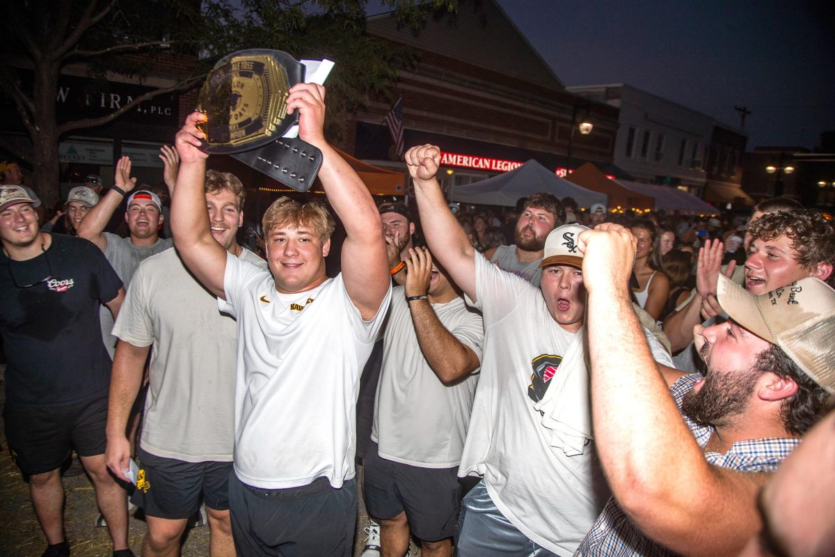 University of Iowa offensive lineman Cael Winter raises his trophy belt after winning the Hay Bale Toss at Solon Beef Days in downtown Solon on Friday, July 17.
