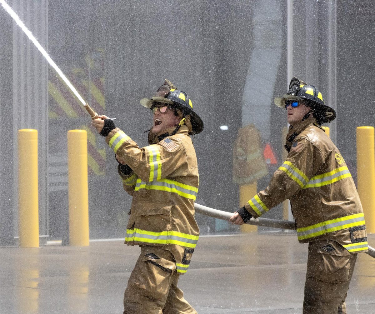 Taking charge during the Firefighters' Waterball Fight, Solon’s Dave Owens (left) — with the help of his teammate — aims with precision to prevent a suspended barrel from going over his head at the Solon Fire Department Saturday, July 18. Nine towns were represented in the traditional firefighters’ competition.
